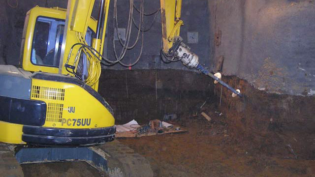 an image of a drill, drilling a support into the wall of a commercial facility