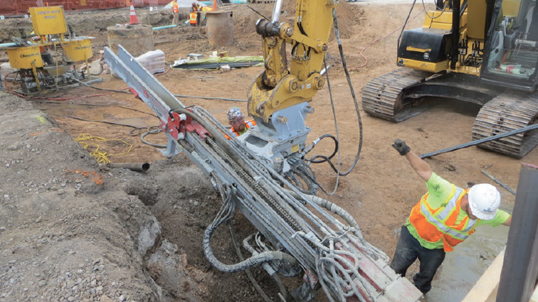 an image of crane and workers and a construction site