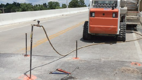 an image of soil nails being placed into the road