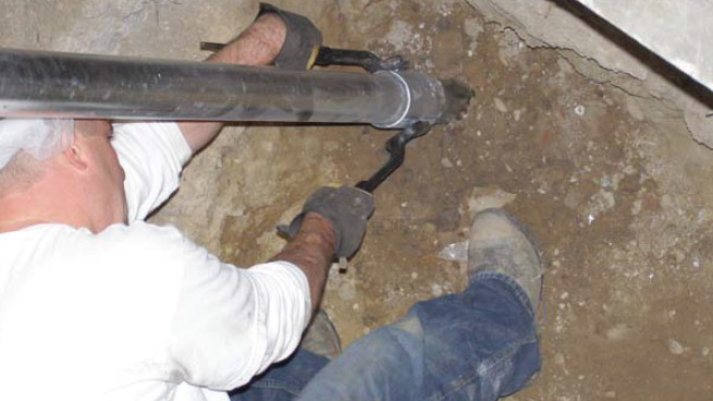 a close up of a worker Tightening a metal pole
