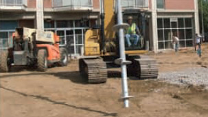 an image a soil nail being placed into the ground