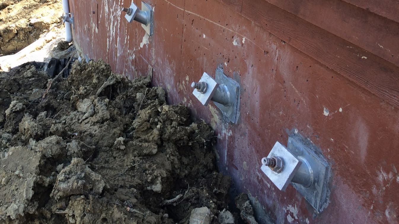 a close up image of a helical Tieback anchors in a wall