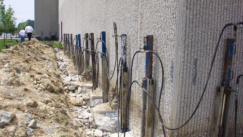 A close of the side of a commercial building with supports being placed