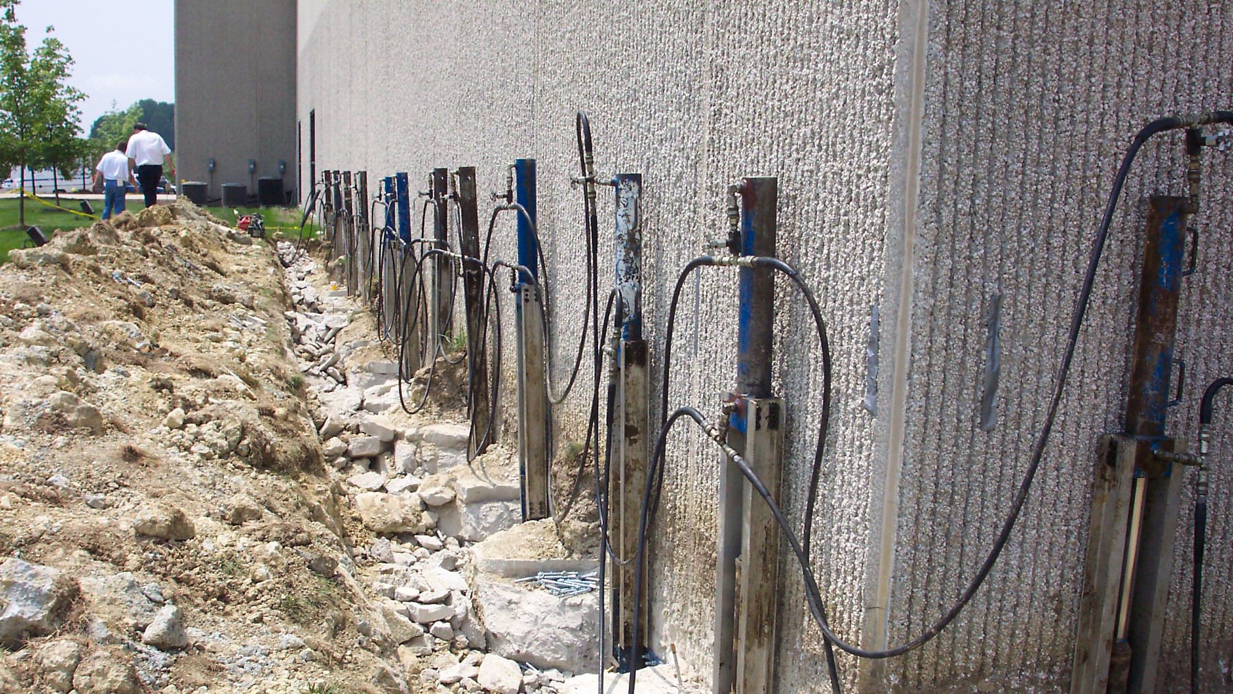 A close of the side of a commercial building with supports being placed