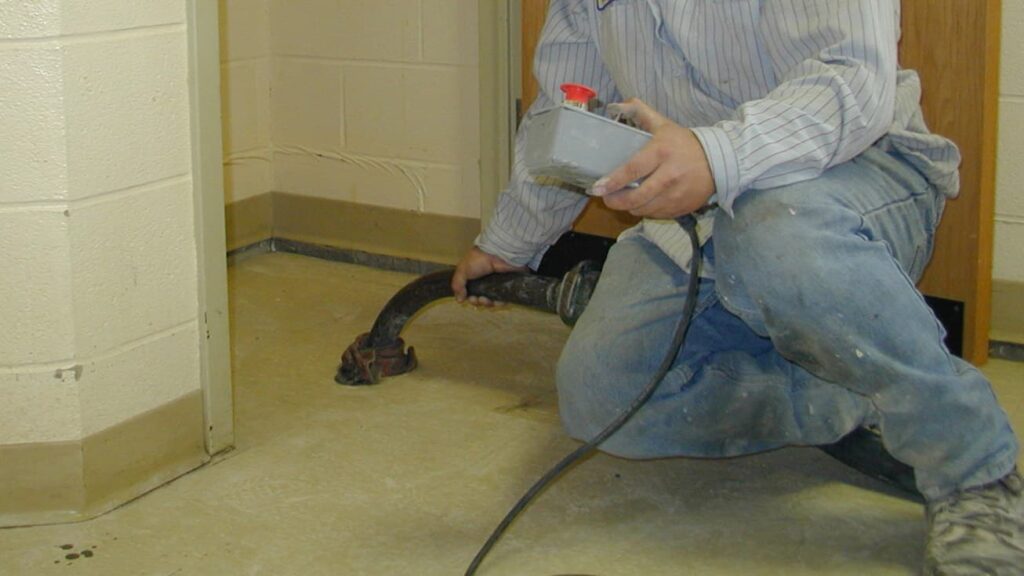 a working using a pump to lift concrete in side of a commercial building