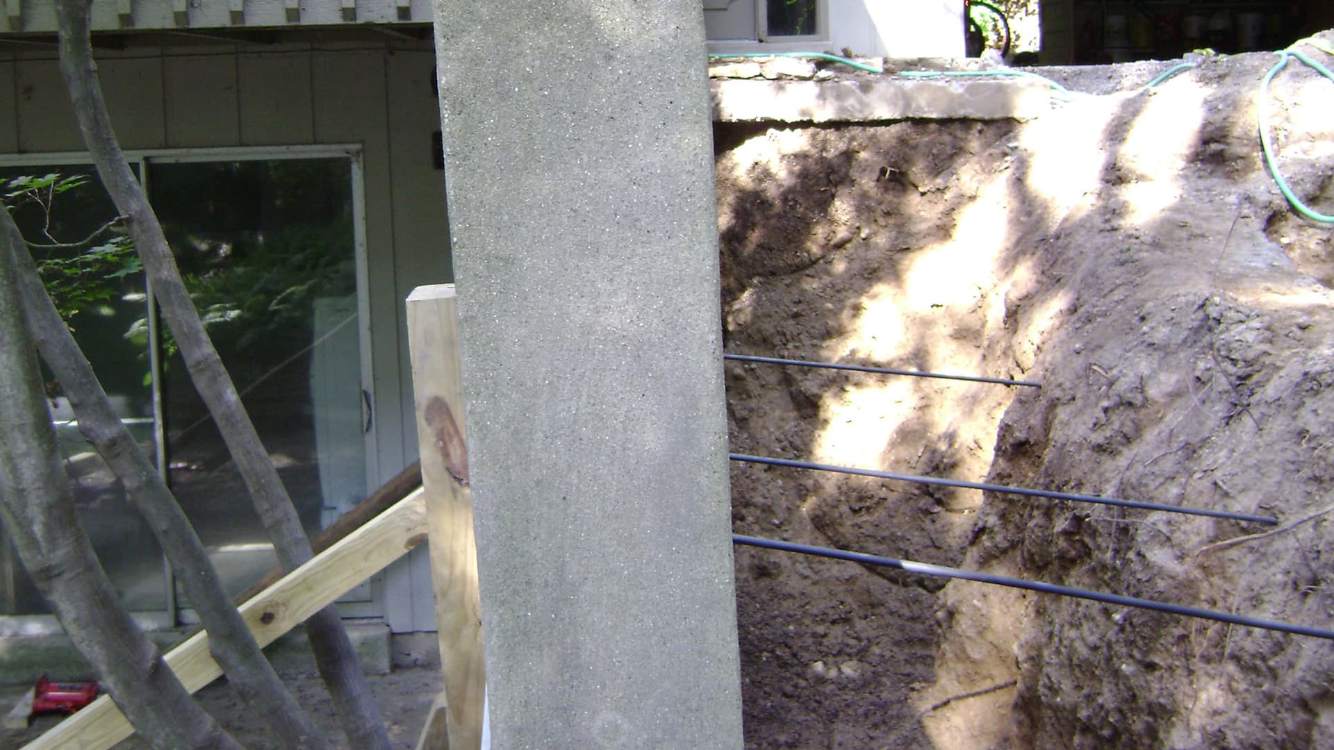 a photo of a foundation with ground support steel tie back system in place
