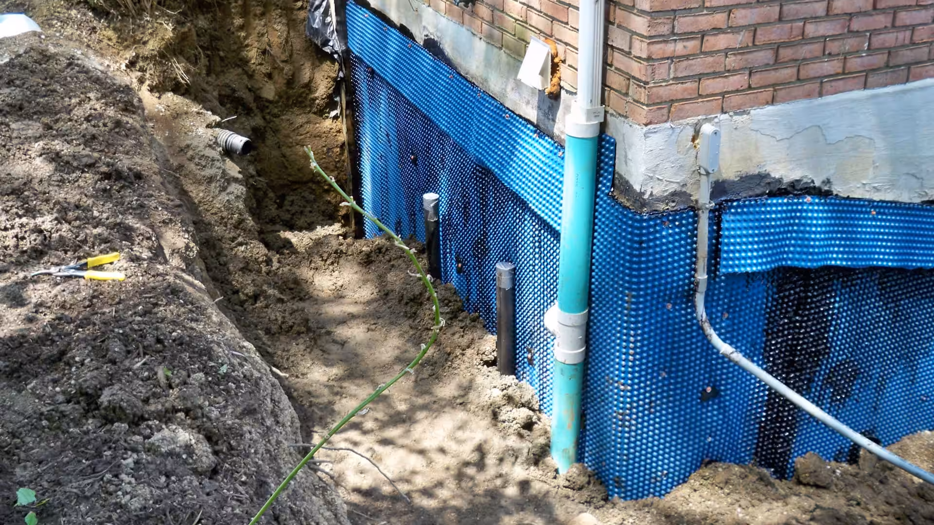 an image of residential foundation being water proofed