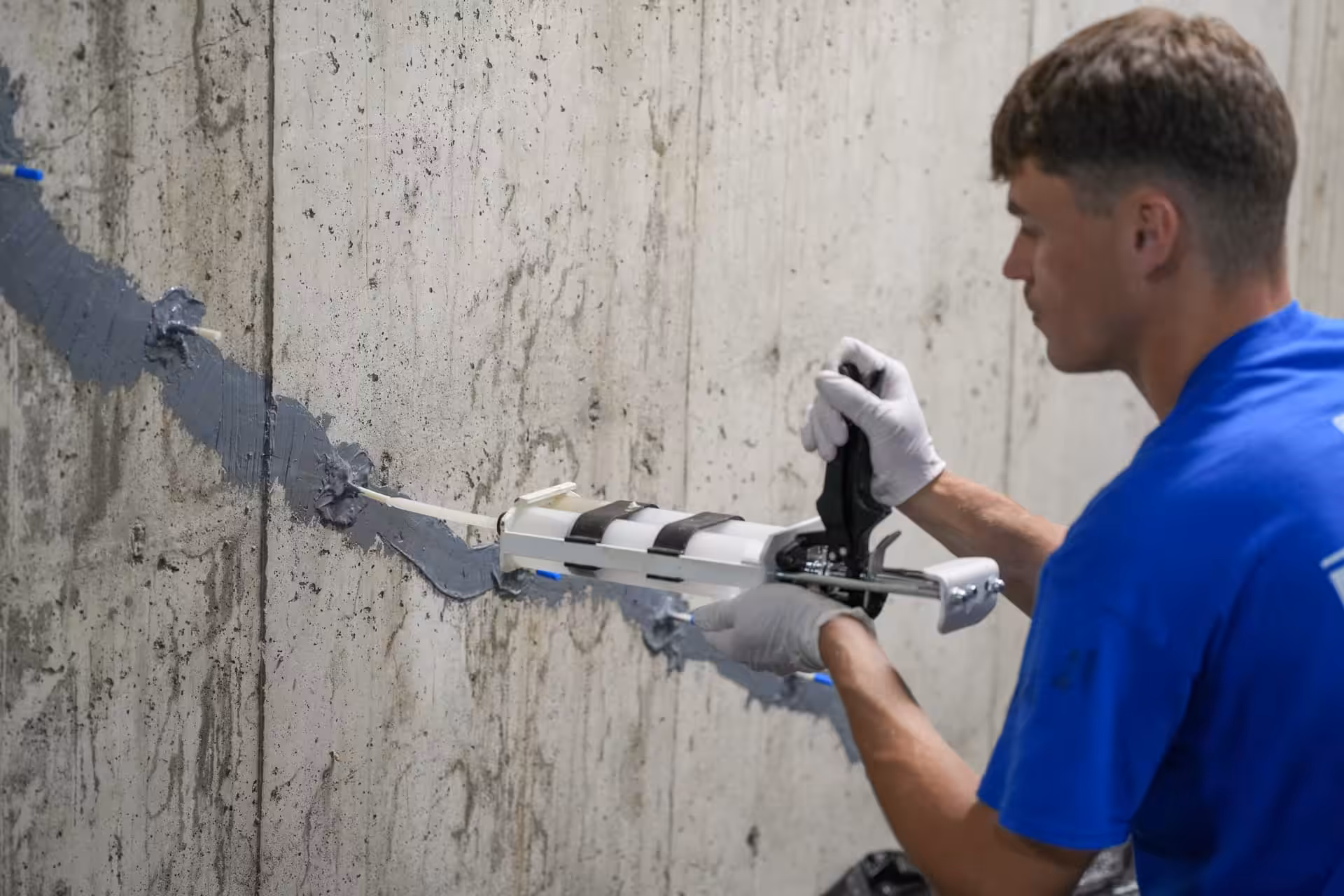 a worker filling in a crack with epoxy